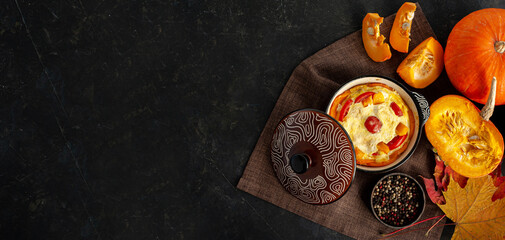 Autumn cooking. Pumpkin casserole on a white wooden background. A place for text. Banner.