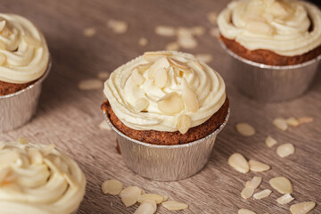 Pumpkin cupcake with white cream and almonds