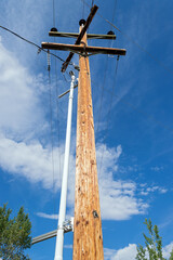 Electric pole against a bright blue sky