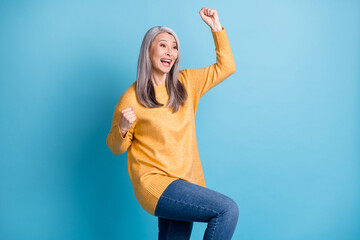 Photo of attractive funny aged lady white grey hairdo hand fists knee raised crazy win prize answer...