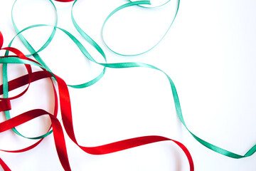 Bright festive red and green ribbon and curl isolated on white background