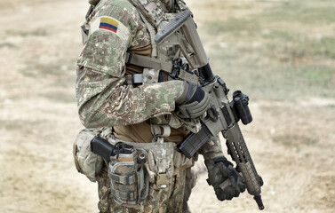 Soldier with assault rifle and flag of Colombia on military uniform. Collage.