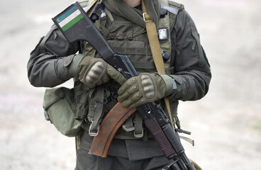 Flag of Uzbekistan on assault rifle butt. Collage.