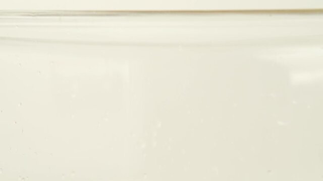 Rotini A Corkscrew Like Shape Pasta Put On A Glass Cookware For Boiling. - Tilt Down Shot