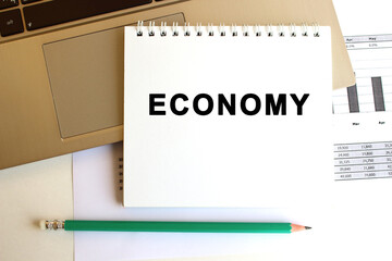 Notepad with the text is on the laptop keyboard. Minimal work space. Business concept.