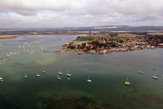 A beautiful aerial view of the village of Bosham and the estuary with yachts at anchor.