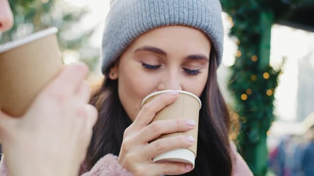 Handheld view of women drinking coffee at the market square. Shot with RED helium camera in 8K.