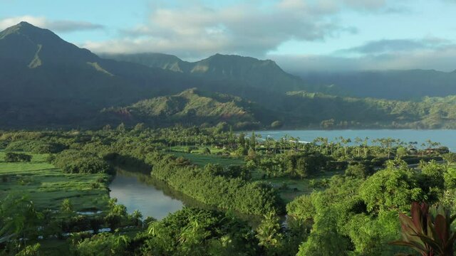 Hanalei Bay Kauai Hawaii perfect reveal shot. Overview nature surrounding mountains and ocean on beautiful sunny morning