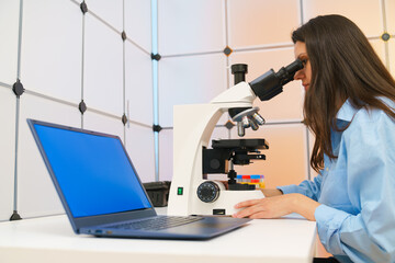 Young woman in a science lab. Health care researchers working in life science laboratory.