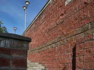Red brick staircase, white lampposts and blue sky