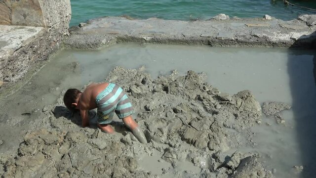 Koycegiz, Mugla, Turkey - 24th of September 2020: 4K At the Sultaniye thermal resort - Kid plays in the healing mud
