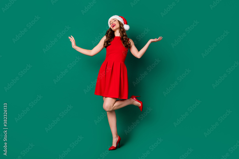 Sticker Full body photo of positive cheerful sweet magnificent lovely girl in santa claus headwear enjoy rejoice x-mas jolly holly event wear legs stilettos isolated green color background