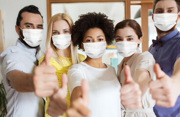 business, pandemic and health concept - creative team wearing face protective medical masks for...