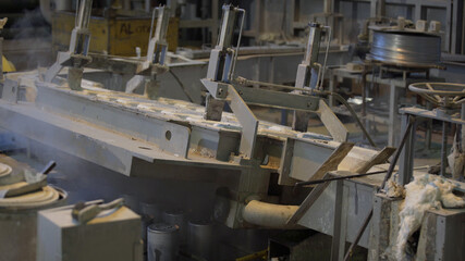 Forming aluminum column after melting in modern factory. Production of aluminium metal profiles, commonly used as material in construction and manufacturing.