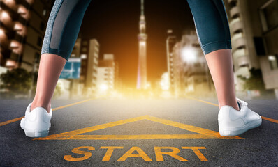 Woman runner legs is standing on a start sign ready to run to goal and freedom on Tokyo night city skyline for motivation begining concept.