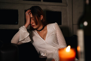 Sad business woman feeling weird after wine party at night.