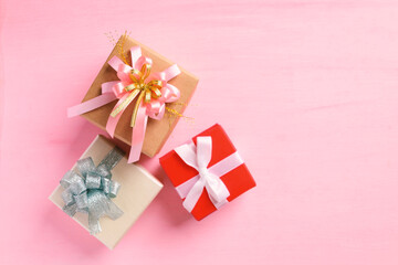 Colorful gift box on pink background, present for giving in special day, Top view