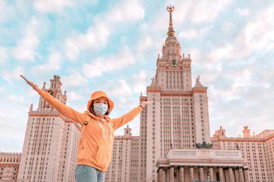 Happy Female Young Student Wearing Medical Mask Rejoices Of The Beginning Of The School Year In Front Of The Main Building Of Lomonosov Moscow State University.