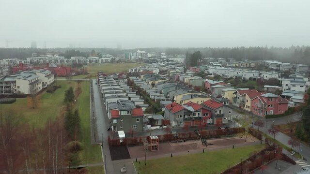 Silverdal Sollentuna suburb in Stockholm, Sweden. Modern high class privileged luxurious residential area drone aerial view on cloudy rainy day. Colorful homes