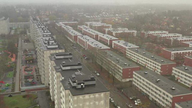 European ghetto 4k aerial drone view of concrete residential housing complex in Sollentuna district borough neighbourhood.