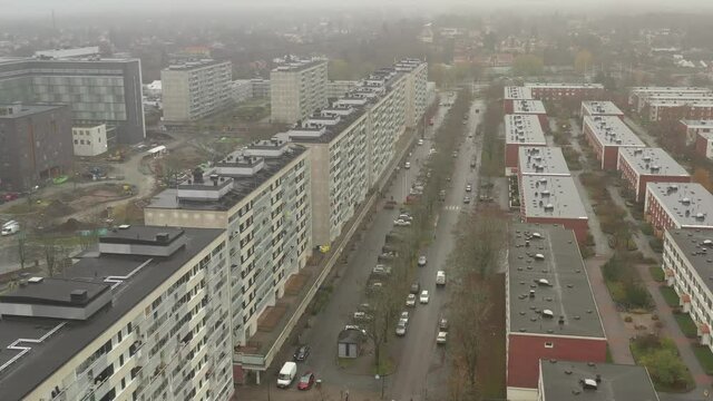 Malmvagen ghetto concrete high rise buildings. rotating drone shot on rainy cloudy misty day in late fall. Tuff suburb of Stockholm, Sweden. Sollentuna neighbourhood