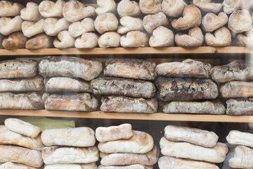 A stack of rustic baguettes at a bakery.