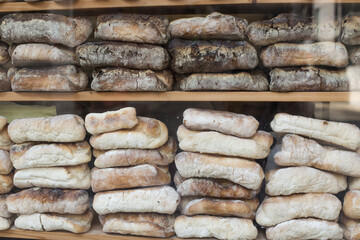 A stack of rustic baguettes at a bakery.
