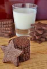 hocolate cookies with a glass of milk on a wooden backdround	