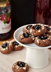 cherry jam chocolate cookies on a white plate