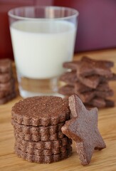 chocolate cookies with a glass of milk on a wooden backdround