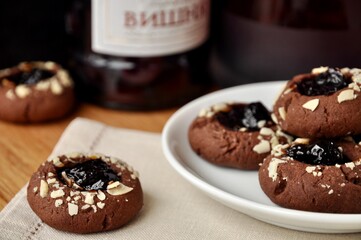 cherry jam chocolate cookies on white plate