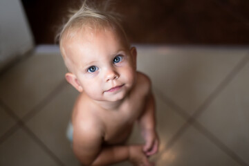 Child girl with blue eyes looking up. Close-up portrait. Selective focus.