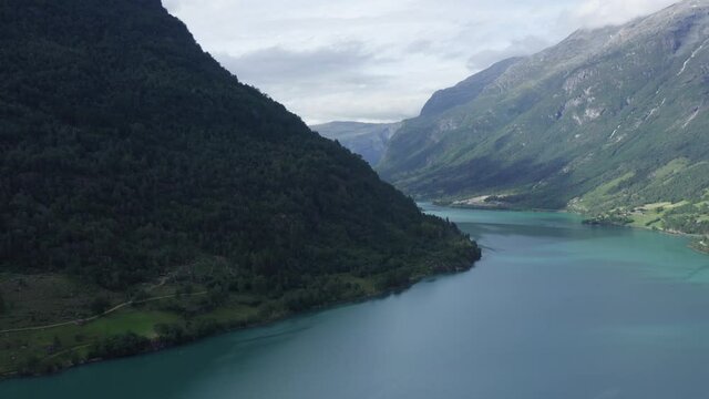 Aerial drone footage over the beautiful lake Oldevatnet in Stryn, Norway. Briksdalsbreen turquoise glacier water in summer