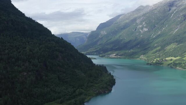 Aerial drone video over the beautiful lake Oldevatnet in Stryn, Norway. Briksdalsbreen turquoise glacier water in summer