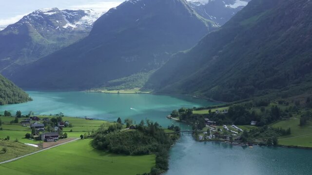 Aerial drone footage over the beautiful lake Oldevatnet in Stryn, Norway. Briksdalsbreen turquoise glacier water in summer time