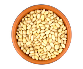 Bowl with pine nuts on white background