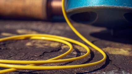 Fly fishing tackle on a wooden background, including reel and line. Close-up.