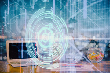 Double exposure of table with computer on background and data theme hologram. Data technology concept.