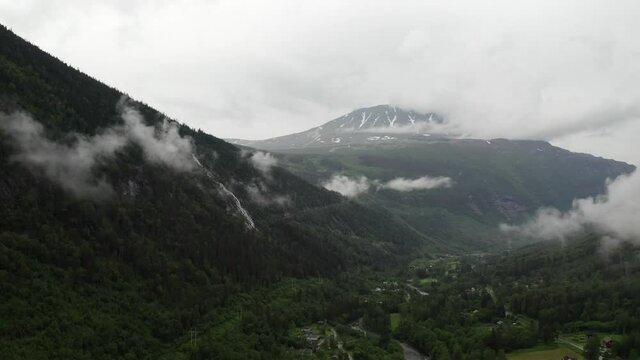 Mysterious moody Norwegian landscape drone shot. Beautiful cloudy morning at Gaustatoppen valley look at the mountain peak. Low clouds
