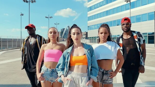 Group of urban dancers performing outdoor. Multi-ethnic hip hop crew dancing and having fun