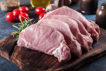 Raw pork loin slices on a chopping board