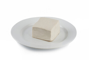 close-up white tofu on a white plate isolated