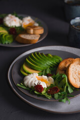 Hearty and healthy breakfast. On a plate are avocado poached egg and bread