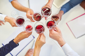 Group of business people drinking red wine