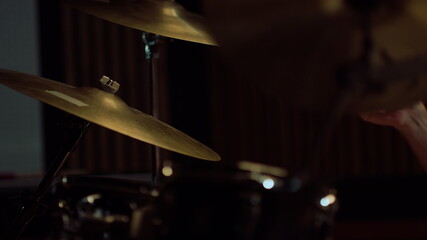 Fototapeta na wymiar Closeup man hands playing on percussion instrument in recording studio.