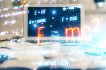 Desktop computer background and formula hologram writing. Double exposure. Education concept.