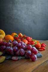 Still life of fresh seasonal fruits of reddish tones