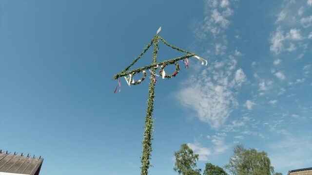 Swedish May or Midsummer pole. Sunny summer day in Sweden. handheld shot circling the object