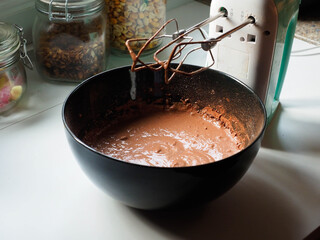 cooking with a rod mixer and sponge cake on a white table