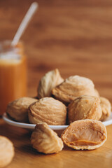 Homemade cookies with boiled condensed milk on a table background. Copy space